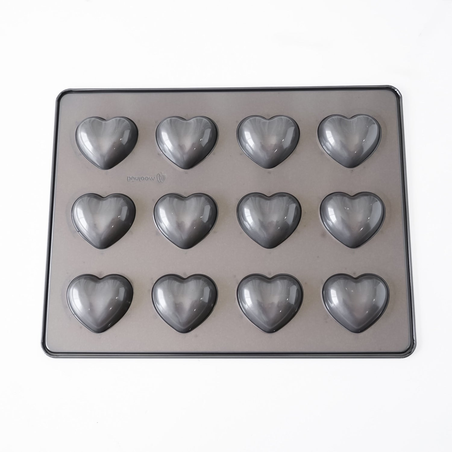 A heart-shaped silicone mold tray with 12 individual heart cavities, shown from a top-down view on a plain white background.
