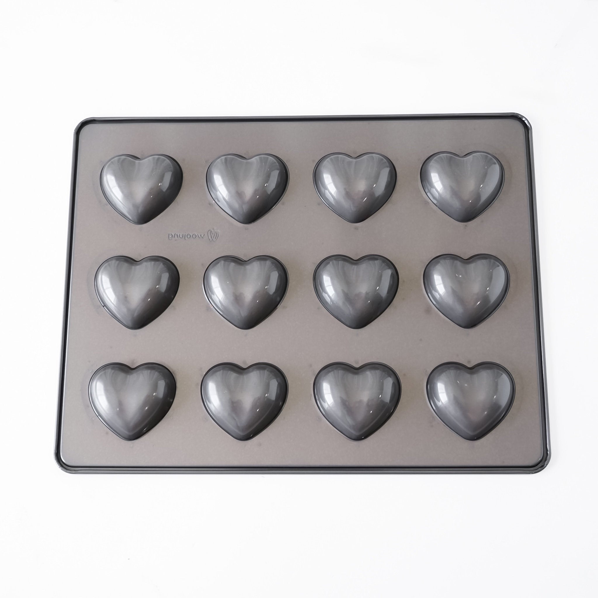 A heart-shaped silicone mold tray with 12 individual heart cavities, shown from a top-down view on a plain white background.