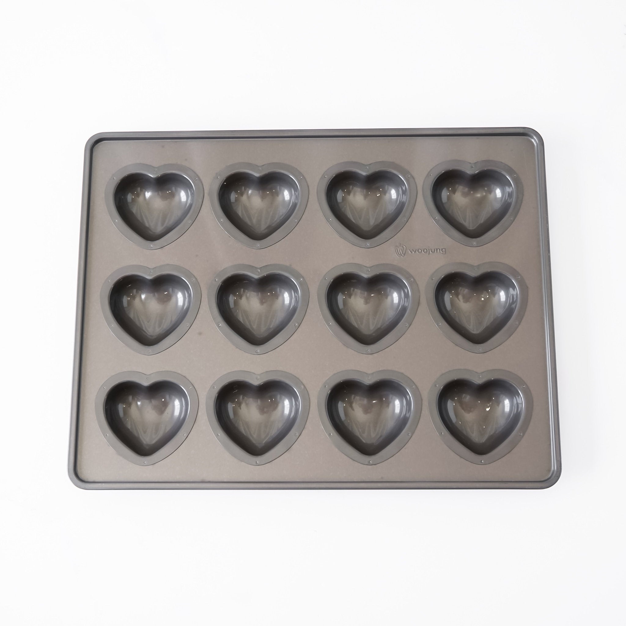 A rectangular gray heart-shaped mold tray with twelve heart-shaped cavities, photographed from above on a plain white background.