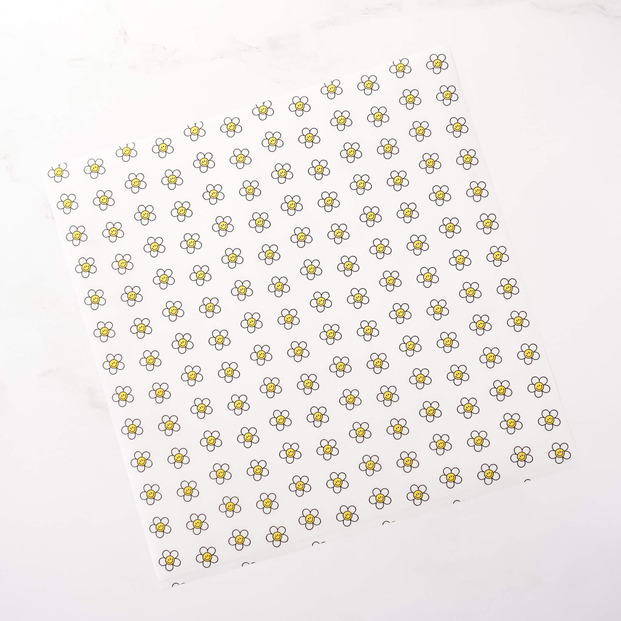 Pattern of small daisy flowers on a white background