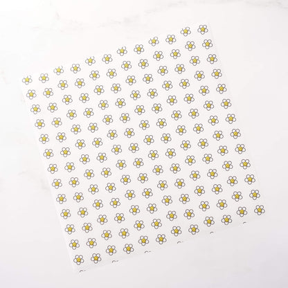 Pattern of small daisy flowers on a white background