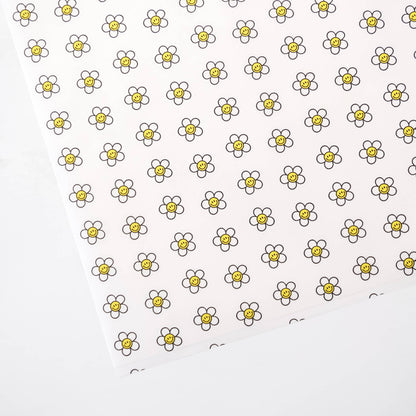 Pattern of smiley daisy flowers with yellow centers on a white background