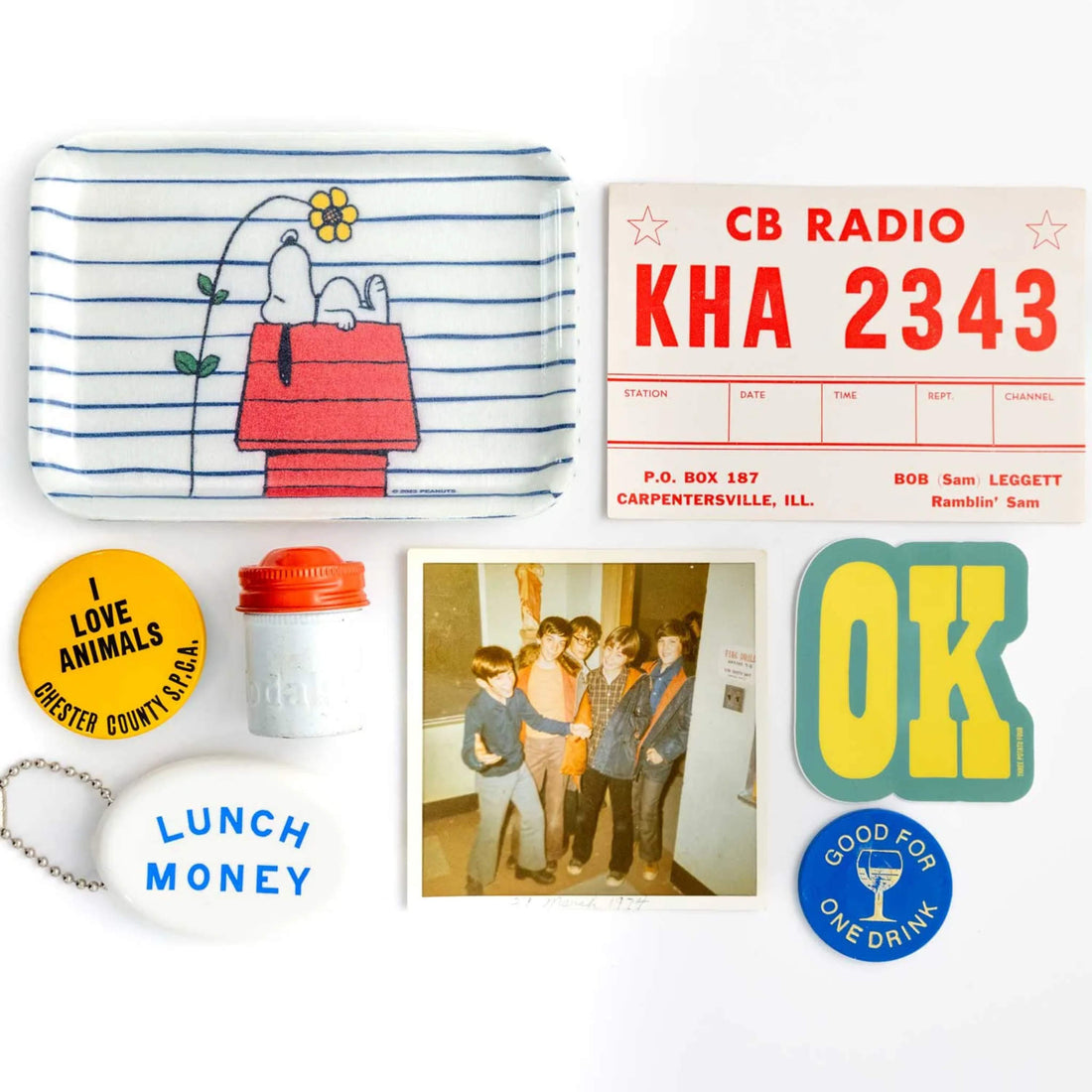 Collection of vintage-style items including a snoopy tray, a radio station sign, a &