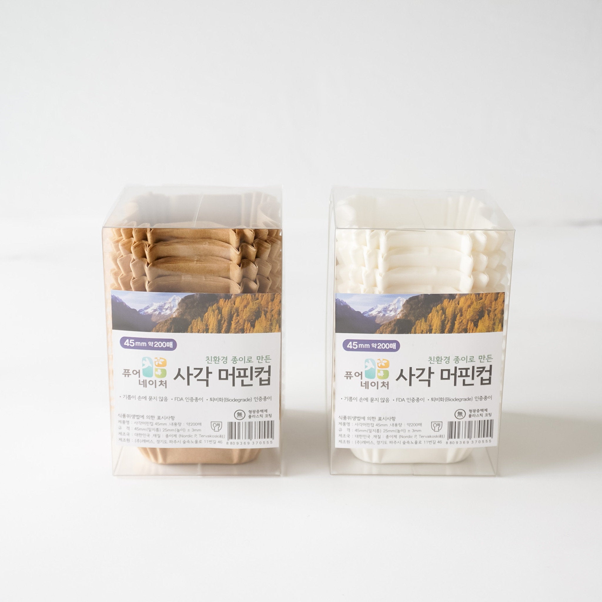 Two boxes of brown and white paper cupcake liners. 