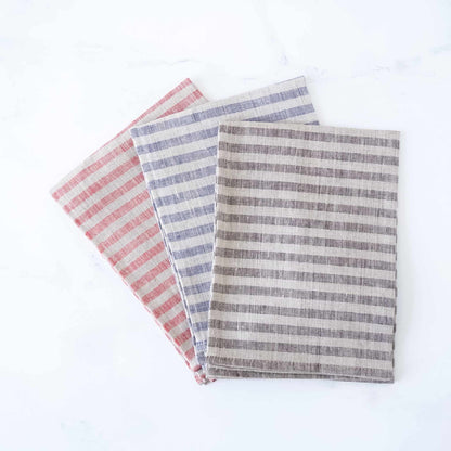 Three striped kitchen towels in red, blue, and gray on a white background