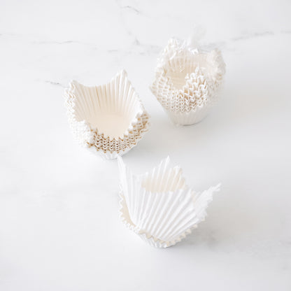 white cupcake liners on a white background