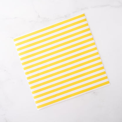 Yellow and white striped deli paper on a white background