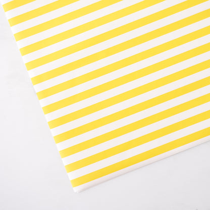 Yellow and white striped paper on a light gray background